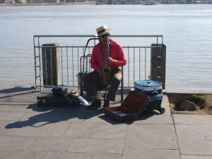 T.S. Lark on the Saxophone on the levee with the Mississippi behind